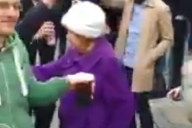 Watch partying pensioner show off her dance moves with pet dog by her side in Soho street jam